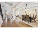 Spacious dining area with hardwood floors, decorative lighting, and an open floor plan at 34 Sommerset Cir, Englewood, CO 80111