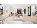 Elegant living room with fireplace, neutral decor, and large windows at 19 S Eudora St, Denver, CO 80246