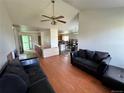 Open-concept living room and dining area with wood floors and contemporary furnishings at 780 2Nd St, Bennett, CO 80102