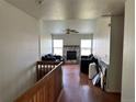 A spacious living room featuring hardwood floors, a fireplace, and lots of natural light at 780 2Nd St, Bennett, CO 80102