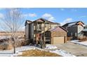 Two-story house with stone accents, a two-car garage, and a balcony at 9066 Sandpiper Dr, Frederick, CO 80504