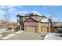 Two-story house with stone accents, a two-car garage, and a balcony at 9066 Sandpiper Dr, Frederick, CO 80504