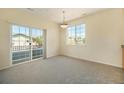 Well-lit living room with balcony access and a view of the surrounding neighborhood at 5255 Memphis St # 315, Denver, CO 80239