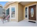 Inviting front porch with seating area and a wood door at 8656 Aberdeen Cir, Highlands Ranch, CO 80130