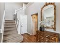 Elegant staircase with hardwood floors and a light-colored railing at 8656 Aberdeen Cir, Highlands Ranch, CO 80130