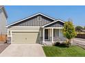 This lovely single-Gathering home features a well-manicured lawn, a two-car garage, and stone veneer accents at 47341 Lily Ave, Bennett, CO 80102