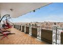 Enjoy city views from this spacious balcony with a swing chair, unique tile flooring, and metal railings for safety at 800 N Washington St # 710, Denver, CO 80203