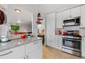 Bright kitchen features white cabinetry, granite countertops, modern appliances, and pass through to the living room at 800 N Washington St # 710, Denver, CO 80203