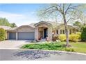 Charming stone home with a well-manicured lawn and a two-car garage, showcasing great curb appeal at 12 Canon Cir, Greenwood Village, CO 80111