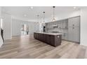 Spacious kitchen with gray cabinets, stainless appliances, and a large island perfect for entertaining at 2347 Kite Route Ln, Superior, CO 80027