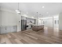 Bright open kitchen featuring gray cabinets, stainless steel appliances, and a large center island at 2347 Kite Route Ln, Superior, CO 80027