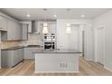 Well-equipped kitchen featuring stainless steel appliances, granite countertops, and pendant lighting at 7306 Watercress Dr, Littleton, CO 80125