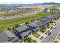 An aerial view of a suburban neighborhood showing rooftops, streets, and green spaces on a bright day at 16486 W 94Th Dr, Arvada, CO 80007