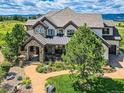 Luxury home with mountain views and a well-manicured lawn at 10887 Rainribbon Rd, Highlands Ranch, CO 80126