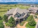 Luxury home with mountain views, landscaped grounds, and a large backyard at 10887 Rainribbon Rd, Highlands Ranch, CO 80126