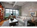 Bright, airy living room featuring an open layout, hardwood floors, and contemporary decor with bicycle accents at 2000 Little Raven St # 1B, Denver, CO 80202