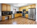 Kitchen with wooden cabinets, stainless steel appliances, and black countertops at 2320 Morningview Ln, Castle Rock, CO 80109