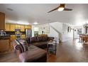 Open-concept living room with hardwood floors, a leather sofa, and stairs to the next level at 2320 Morningview Ln, Castle Rock, CO 80109