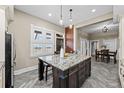 Spacious kitchen with a large center island, modern lighting, and open layout at 2927 N Humboldt St, Denver, CO 80205