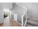 Bright entryway featuring a stairway with iron spindles, wood flooring, and neutral paint colors at 610 Mosquito St, Elizabeth, CO 80107