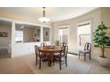 Open dining room featuring neutral paint, carpeted floors and large windows for natural light at 461 N Marion St, Denver, CO 80218