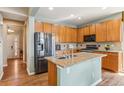 Kitchen features stainless steel appliances, granite counters, hardwood floors and ample cabinet space at 19602 E 63Rd Dr, Aurora, CO 80019