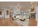 Inviting living room boasts a fireplace, hardwood floors, and an open layout to the kitchen at 3535 Medallion Rd, Castle Rock, CO 80104