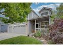 Charming home with a cozy front porch, well-manicured lawn, and a convenient two-car garage, blending comfort and functionality at 9079 Garnet St, Highlands Ranch, CO 80126