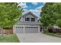 Beautiful two-story home with a two-car garage, manicured lawn, and a welcoming front porch, perfect for relaxing outdoors at 9079 Garnet St, Highlands Ranch, CO 80126
