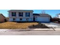 Charming two-story home with a well-manicured lawn and a freshly paved driveway at 9749 Steele St, Thornton, CO 80229