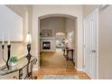 Elegant entryway showcasing hardwood floors and an arched doorway leading into the living room at 20715 Bridlewood Ln, Parker, CO 80138