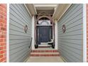 Inviting covered front porch with stylish decor leading to a modern front door at 20715 Bridlewood Ln, Parker, CO 80138