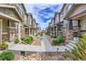 Street view featuring townhomes with unique color schemes, stylish accents, and community appeal at 16818 E 119Th Ave # A, Commerce City, CO 80022