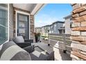 Relaxing front porch with seating, outdoor decor, and a welcoming view of the neighborhood at 16351 Askins Loop, Parker, CO 80134