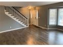 Inviting living area with a staircase and natural light streaming through the window at 7565 S Cove Cir, Centennial, CO 80122
