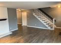 Open living space featuring stylish hardwood floors and an elegant staircase at 7565 S Cove Cir, Centennial, CO 80122
