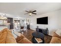 Open-concept living room featuring hardwood floors, a ceiling fan, and seamlessly connected to the dining area at 1049 Lilac St, Broomfield, CO 80020