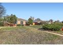 A single story home with xeriscaping; the sidewalk separates two lots at 2220 Quebec St, Denver, CO 80207