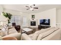 Comfortable living room with a fireplace, hardwood floors, and neutral decor at 7956 S Grand Baker Way, Aurora, CO 80016