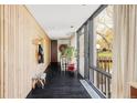 Bright hallway featuring floor-to-ceiling windows and wood paneling for a modern and welcoming entry at 7170 W 8Th Pl, Lakewood, CO 80214