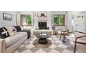 Bright living room features fireplace, neutral decor, and stylish rug at 11 S Albion St, Denver, CO 80246