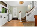 Bright foyer with hardwood floors, stained glass window details and an elegant staircase at 1154 N Clarkson St, Denver, CO 80218