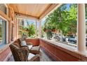 Relaxing front porch featuring comfortable seating and hanging plants, perfect for enjoying the outdoors at 1154 N Clarkson St, Denver, CO 80218