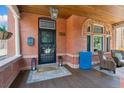Inviting front porch with stone accents, comfortable seating and a beautifully stained wood ceiling at 1154 N Clarkson St, Denver, CO 80218