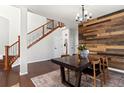 Elegant dining room with wood floors and statement wall at 12773 E 105 Th Pl, Commerce City, CO 80022