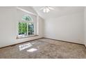 Bright bedroom featuring a large window and plush carpeting at 13457 Glen Cir, Broomfield, CO 80020