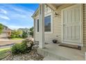 View of the front porch with well-manicured garden, covered entryway, and detailed trim at 2659 S Halifax St, Aurora, CO 80013