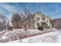 Beautiful two-story house with a large mature tree in the yard, covered in a fresh dusting of snow at 1100 N Marion St # 4, Denver, CO 80218