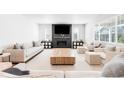 Bright living room featuring modern fireplace, plush seating, and large windows at 777 Gold Hill Dr, Erie, CO 80516