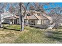 Multi-level home nestled amongst mature trees and landscaping at 2 Elm St, Denver, CO 80220